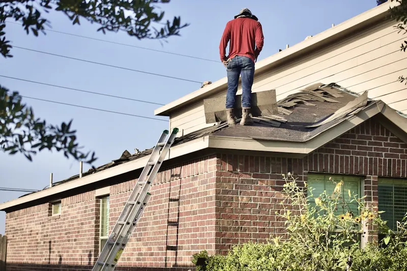 Professional roofer working on a residential roof in Breezy Lake